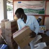 A man in Sudan holds a box of medical supplies