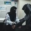 Woman providing health check up to a patient