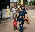 A woman wearing a mask as a preventive measure enters Kyeshero Hospital after passing a checkpoint for hand washing and health screening in Goma