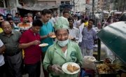 Zafar serves food from his food cart, Bangladesh. Photo: Abbie Trayler-Smith / Concern Worldwide.
