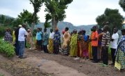 Concern Rwanda staff talk to beneficiaries of the Farmer Field Schools in Gishubi Sector, Gisagara District. Photo: Donna Ajamboakaliza / Concern Worldwide.