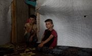 Syrian refugees *Omar,8, and *Bilal, 10, are pictured in the garage which they are currently living, in Northern Lebanon. Photograph by Mary Turner