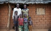 Estella Bissabogoyo (28) with her husband Gustave (31) and four of their children Jordy (8), Israella (4), Corine (3) and Jupsie (2) outside their home in the village of Gbadengue. Estella is part of a village seed group to receive seeds, tools and technical assistance from Concern. Photographer: Chris de Bode