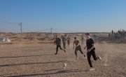 In northwest Iraq, Michael Darragh MacAuley joins in on a game of soccer on some open ground. Photo: Gavin Douglas/Concern Worldwide. 