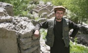 Joma Khan, by the remains of his home in Northeastern Afghanistan, which was destroyed by a flash flood in 2014. Concern has suppported the community to establish watershed protection on the vulnerable hillsides, to prevent further erosion and landslides. Photo: Kieran McConville / Concern Worldwide