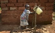 Joella, 5, washes her hands using a tip-tap and soap in Burundi. Photo: Chris de Bode