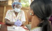 Nurse Emma Senesie at a screening area at Waterloo PHU in the east of Freetown checks all patients and visitors for signs of Ebola before they enter during Ebola outbreak in Sierra Leone.