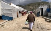 A man keeps a social distance from others as he returns home after receiving a hygiene kit in a camp in Northern Iraq. Photo: Concern Worldwide.