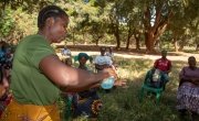 Agness, a Community Health Volunteer demonstrating how she will teach people handwashing. Photo: Henry Mhango
