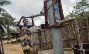 Mother-of-one Naomi Kpehyou collects water from the communal water pump in Ceayeh Town, Liberia. Photo: Nora Lorek