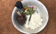 A bowl of mashed cassava, palm nuts, avocados, mushrooms and tomatoes that Natalie Wato's family have bought for their evening meal. Photo: Chris de Bode