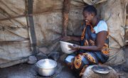 Dukan* lives with her family in a POC in Juba, South Sudan. Here, she is cooking Walwal. Photo: Abbie Trayler-Smith