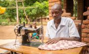 After receiving a business grant and training, the couple invested in a sewing machine and started a tailoring business