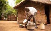 Since completing the Umodzi gender programme, Forty helps with the dishes and other household duties in Nsanje, Malawi