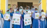 Girls learn how to protect people from covid-19 in their school in Pakistan