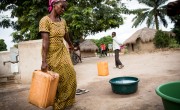 Gisele draws water from a pump installed in her village with help from Concern.