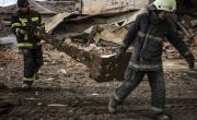 Fire fighters clear debris from a fire station in Kharkiv, Ukraine.