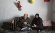 Syrian refugees Khaled*, left, and Fatima* sit on a mattress at their home at an informal tented settlement in the village of Samounniye, Akkar, north of Lebanon. Photo: Dalia Khamissy/ Concern Worldwide