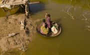 Local boy, Aqib Aliin transports people on his curry frying pan across the flooded waters in Jhuddo town of District Mirpurkhas of Sindh. Photo: Emmanuel Guddo/Concern Worldwide