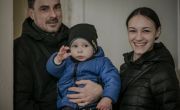 A couple and their young son at a local hub in Ukraine