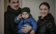 A couple and their young son at a local hub in Ukraine