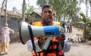 Ashraf is president of a community alert group in Rangpur, Bangladesh. Wearing lifejackets, he and other committee members use loudspeakers to warn local people of the impending threat of cyclones, as part of a Zurich Foundation programme.