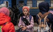 Young Ukrainian girl waiting on train to cross border