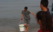 People collect sea water in southern Gaza, to use the water for cooking, cleaning and personal hygiene. Photo: Concern Worldwide