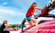 Particpants running through inflatable 