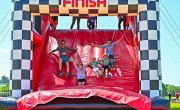 Particpants sliding down inflatable