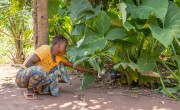 Maria, a beneficary of the 'Cash for Work' component under the EAST Programme, feeds her ducks. Photo: Samuel Isenge/Concern Worldwide.