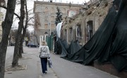 A woman walks by a building damaged by an airstrike in Kharkiv — one of the regions hit hardest by the conflict in Ukraine. Photo: Jon Hozier-Byrne/Concern Worldwide
