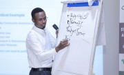 A man writes on a whiteboard.