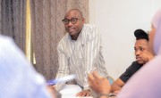 A man talking to others at a conference.