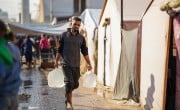A man carries water containers
