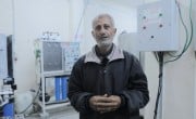 A man stands in front of a water filter in a hospital