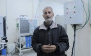 A man stands in front of a water filter in a hospital