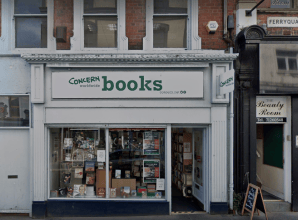 Concern Worldwide Books shopfront with white signage, street entrance, and window display of books and posters.