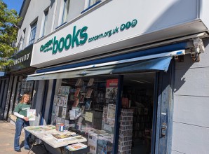 Charity shopfront with Concern Worldwide branding on a white background and large books wording on a highstreet.