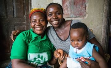 Maternal and Newborn Health Promoter Kai Jigba with a Concern-trained former traditional birth attendant Maddie Sanoh and baby Mamie. Photo: Kieran McConville / Concern Worldwide.