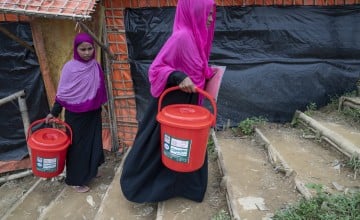 40-year-old widow Tayma* receives a dignity kit from Concern. It consists of a torch, bucket and lid, soap, flip flops, shawls, underwear and sanitary pads. Photo: Abir Abdullah/ Concern Worldwide