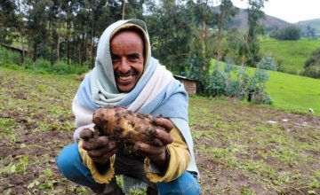 Concern-supported farmer Ahimed Ali Mahamed happily shows off potato crop produce, Ethiopia Photo: Jennifer Nolan