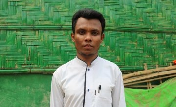 Amir* has been a refugee in Bangladesh since 2017. Now we works as a volunteer for Concern, screening young children for malnutrition. Photo:  Sabrina Idris / Concern Worldwide.
