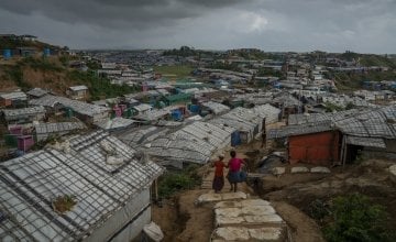 Two people look over Rohingya refugee camp