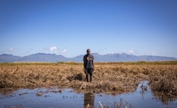 Recently married Patrick Ghembo of Monyo Village, Malawi, standing in his field, destroyed by the floods. Patrick is a farmer of maize and rice. He and his wife must rely solely on fishing until he can plant again. They will stay at the displacement camp until the floods have fully subsided. Photo: Gavin Douglas