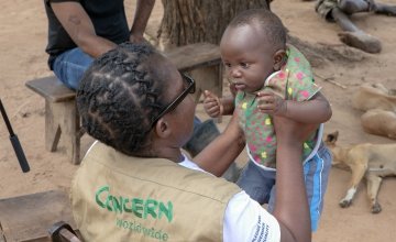 Concern Program Manager Akunsito Kananji with Baby David in Malawi. David's family home was washed away with all their belongings. David's family are casual labourers. With no crops to harvest, his parent won't have any work this season. Photo: Gavin Douglas