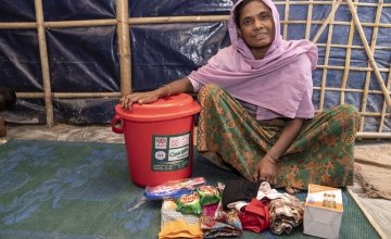 40-year-old widow Tayma* receives a dignity kit from Concern. It consists of a torch, bucket and lid, soap, flip flops, shawls, underwear and sanitary pads. 