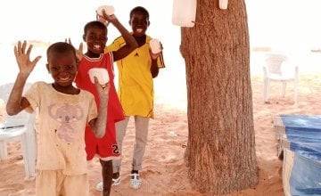 Three brothers attend a Covid-19 awareness session in Tahoua, Niger. 