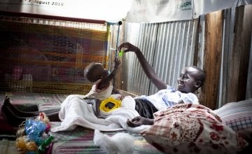 Dehlia* with her sister Koaloch* hang out in the mother and baby room in the Concern Nutrition Clinic in a POC in Juba, South Sudan. Photo: Abbie Trayler-Smith