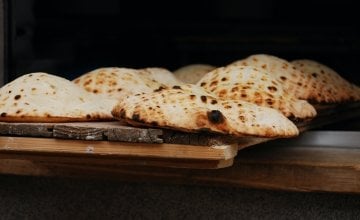 Flatbreads on a wooden chopping board